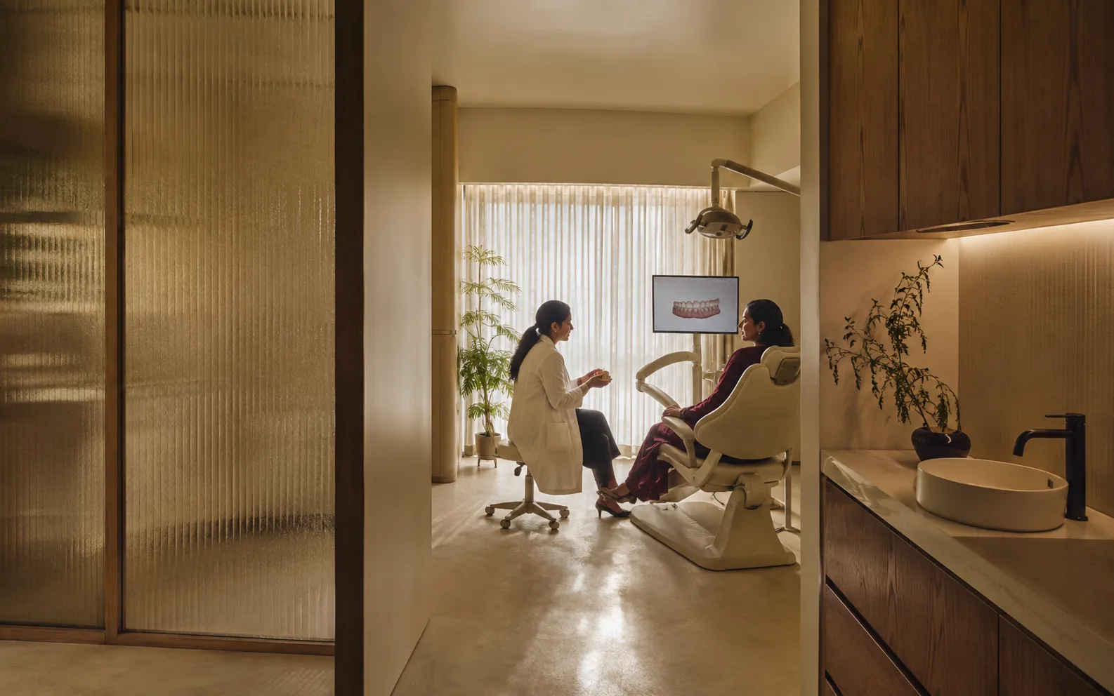 A calm dental consultation taking place in a warmly designed studio